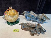 Overall photo showing Murano King Frog art glass and two blue ceramic pottery pieces.