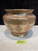 Front angled view of the Persian brass vase showing detailed floral and geometric engravings and wide flared rim.