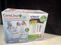 Photo of the boxed VTech CareLine Home Safety Telephone System SN6197 showing front and side of box with product features.