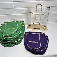 Photo showing entire set with bottle dispenser and all green and purple Crown Royal bags arranged in stacks.