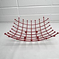 Front view of the bright red wire fruit basket showing grid design and rounded wire ends
