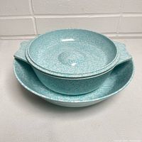 Stacked view of the casserole dish and bowl showing the speckled egg blue pattern.