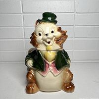 Front view of the ceramic squirrel cookie jar with top hat and jacket.