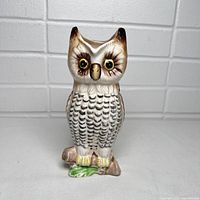 Front view of the vintage owl pitcher showing detailed feathers, eyes, and branch base