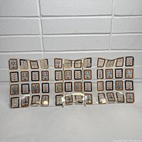 Front view of wavy glass tray showing gold bordered squares with leaf motifs