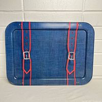 Front view of the rectangular tray showing denim pattern with printed red suspenders and silver buckles