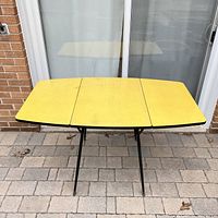 Front view with both leaves open showing full tabletop