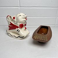 Two vintage planters side by side: a ceramic dog planter and a wooden planter with brass decoration