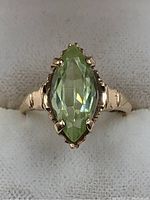 Front view showing the full marquise peridot and band.