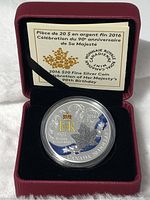 Front view of the commemorative coin in a round plastic capsule inside a red display box with certificate behind.
