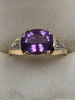 Top view of ring showing oval amethyst and side diamonds