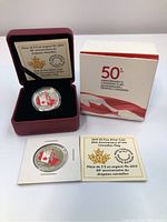 Full view of the silver coin in maroon display case, certificate card, and original outer packaging box.