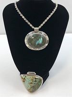 Front view of sterling silver rope chain necklace displayed on black bust with labradorite pendant and separate turquoise pendant below