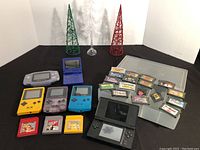 Group shot of all six handheld consoles and game cartridges on display