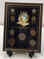 Full photo of framed Royal Windsor Collection Pre-Decimal British Coins with 8 coins mounted and labeled on black background.