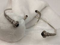 Choker and bracelet open cuffs on white cloth showing entire set