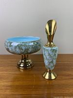 Two-piece set showing turquoise crackled glazing and gold brass bases and accents, pitcher and matching vase bowl-shaped on pedestal.