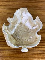 Top view of the maple leaf shaped dish showing detailed embossed veins and speckled glaze finish.