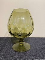 Green mid century optic glass snifter vase with textured bubbles on stem and footed base, shown front view