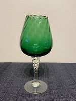 Front view of mid century green optic glass balloon snifter or candle holder.