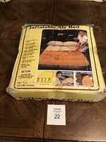 Box of vintage inflatable air bed showing product details and images of the bed in use