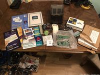 Lot overview showing computer parts, cables, white computer mouse, and numerous business card supplies including Avery packaging and blank sheets.