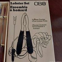 Close-up photo of box packaging showing product name, brand OBO, and illustration of lobster cracker and picks.