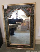 Full front view of the beveled wall mirror showing the arched top and floral crackled painted frame with roses.