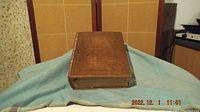 Closed leather bound bible lying on foam case, covers visible
