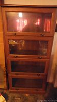 Front view of the closed barrister bookcase showing four glass front doors with metal knobs