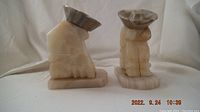 Pair of carved onyx bookends depicting stylized forms with flat tops, set on rectangular bases.