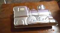 Top view of assembled 3D train cake pan showing front and side of train with detailed features.