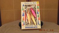 Box labeled 'Boules de Noël' containing 4 elongated teardrop shaped glass ornaments in metallic gold and pink colors