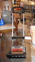 Front view of Craftsman electric snow thrower showing metal handles, motor cover with labels, and plastic auger housing.