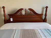Front view of queen size bed headboard with Queen Anne styling and cherry finish.