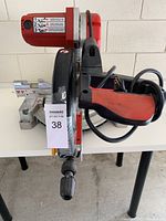 Full view showing the chop saw with motor housing and handle, blade guard, and miter base with angle adjustments.