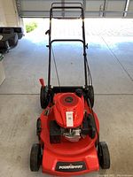 Front view of the red Powersmart self-propelled lawnmower showing handle, engine cover, and wheels.