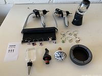 Full overview of the wine accessories lot showing all items on white surface.