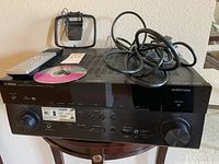 Front view of Yamaha RX-A840 AVENTAGE receiver with remote and cables on top.