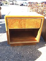 Front view of the Drexel side table showing drawer with vertical lines and open storage below, highlighting wood grain and condition.
