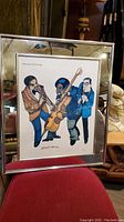 Front view of signed lithograph depicting three musicians, showing full artwork and mirrored frame.