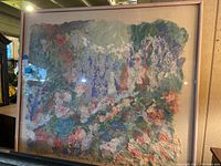Photo of framed abstract textured wall art featuring pastel floral and organic shapes with a pink wooden frame.