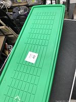 Large green plastic storage container for holding the Christmas items