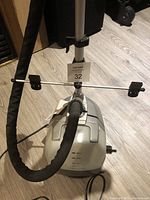 Full view of Conair clothes steamer including base unit, adjustable pole, hanger with clips, and attached flexible hose.