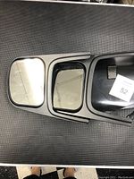 Photo showing front view of dual mirrors with clip-on mount, including smaller convex mirror on left side unit.