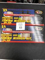 Two boxed Universal Bar Towing Mirror Kits showing front packaging with branding, model number, and kit features.
