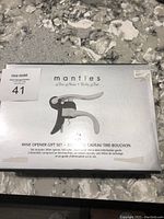 Closed Mantles wine opener gift set box with brand and content information visible.