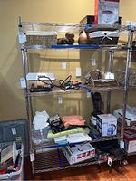 Full view of shelving unit with contents to illustrate structure, chrome finish, and size.