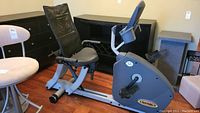Side angle view of the Sports Art C52r recumbent exercise bike showing seat, pedals, frame and console display.