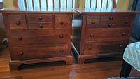 Pair of matching wooden nightstands in medium brown finish with visible scratches, showing front view and drawer configuration.